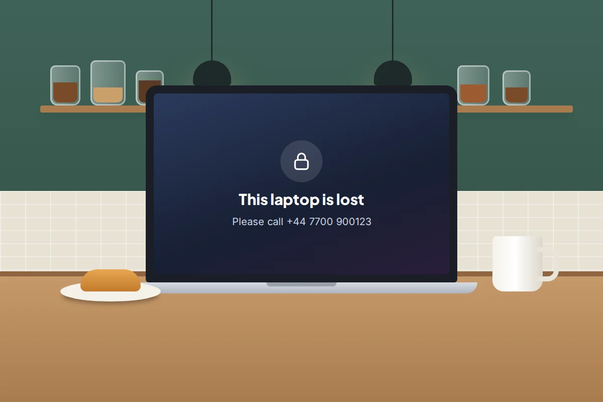 An open laptop on a café table, its screen locked with a padlock and a message asking the finder to call a phone number