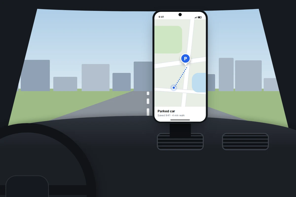 A car dashboard with a phone in a vent mount showing a map with a blue P parking pin and a dotted walking route