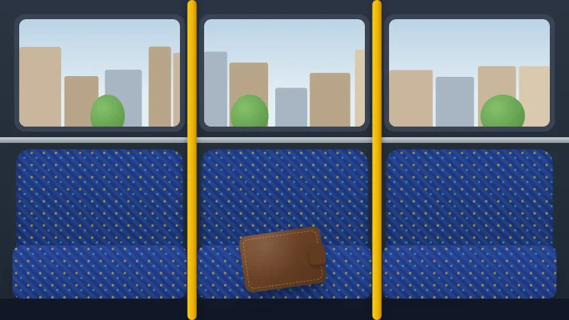 A row of patterned bus seats under windows looking onto a street, with a brown wallet left behind on one seat