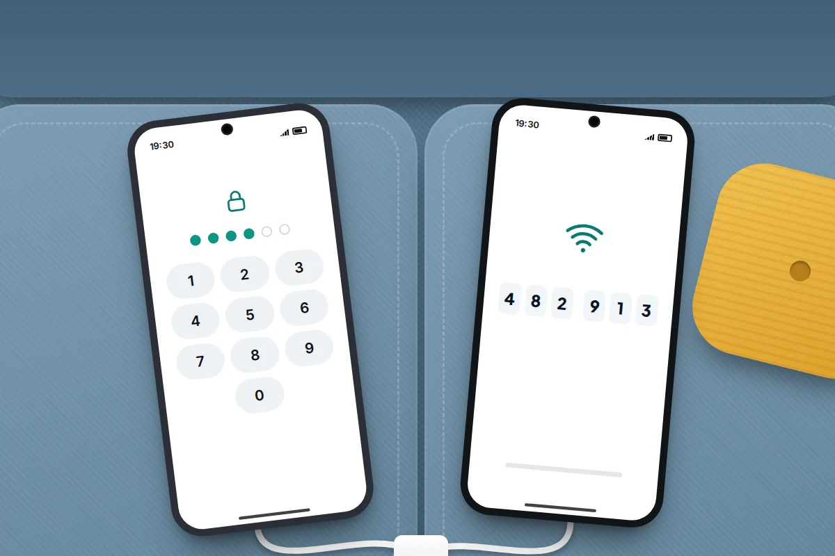 Two phones on a sofa cushion, both plugged in, the new one showing a six-digit code and the old one a number keypad