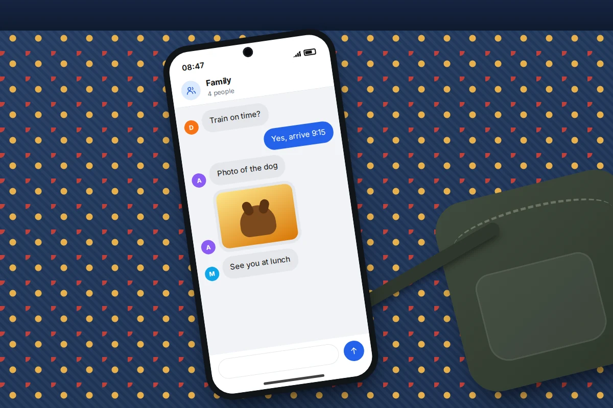 Phone lying on a patterned train seat, showing a four-person family group chat with a photo of a dog