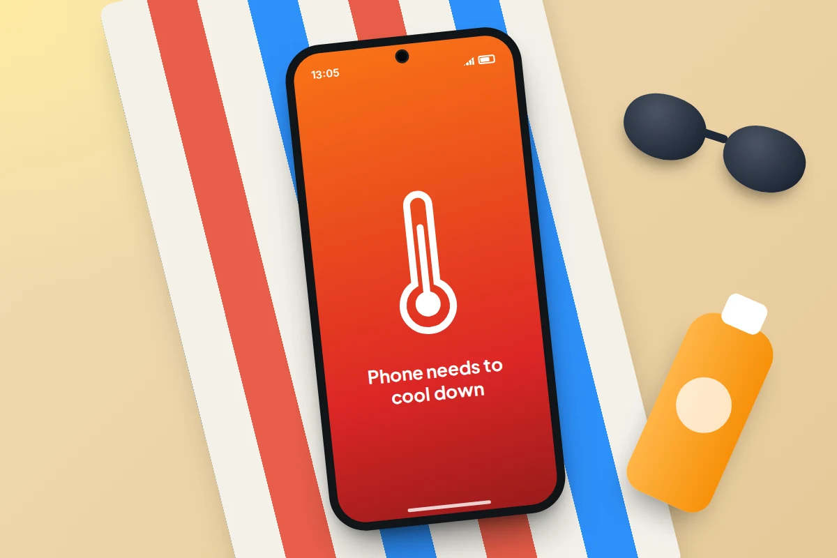 A phone on a striped beach towel in the sun showing a thermometer and a cool-down warning, beside sunglasses and sun cream