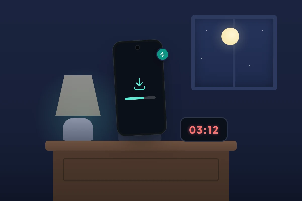 A dark bedside table at night with a phone on charge showing an update progress bar beside a lamp and an alarm clock