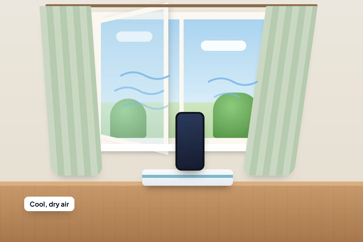 A phone standing upright on a folded towel on a table in front of an open window, with breeze lines