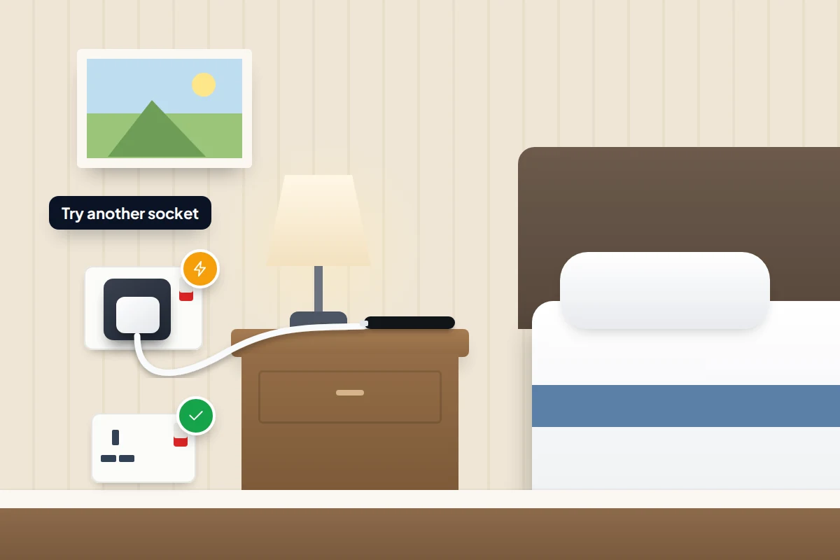 Hotel room wall with a travel adapter in one socket, a spare socket below, and a cable running to a phone on a bedside table