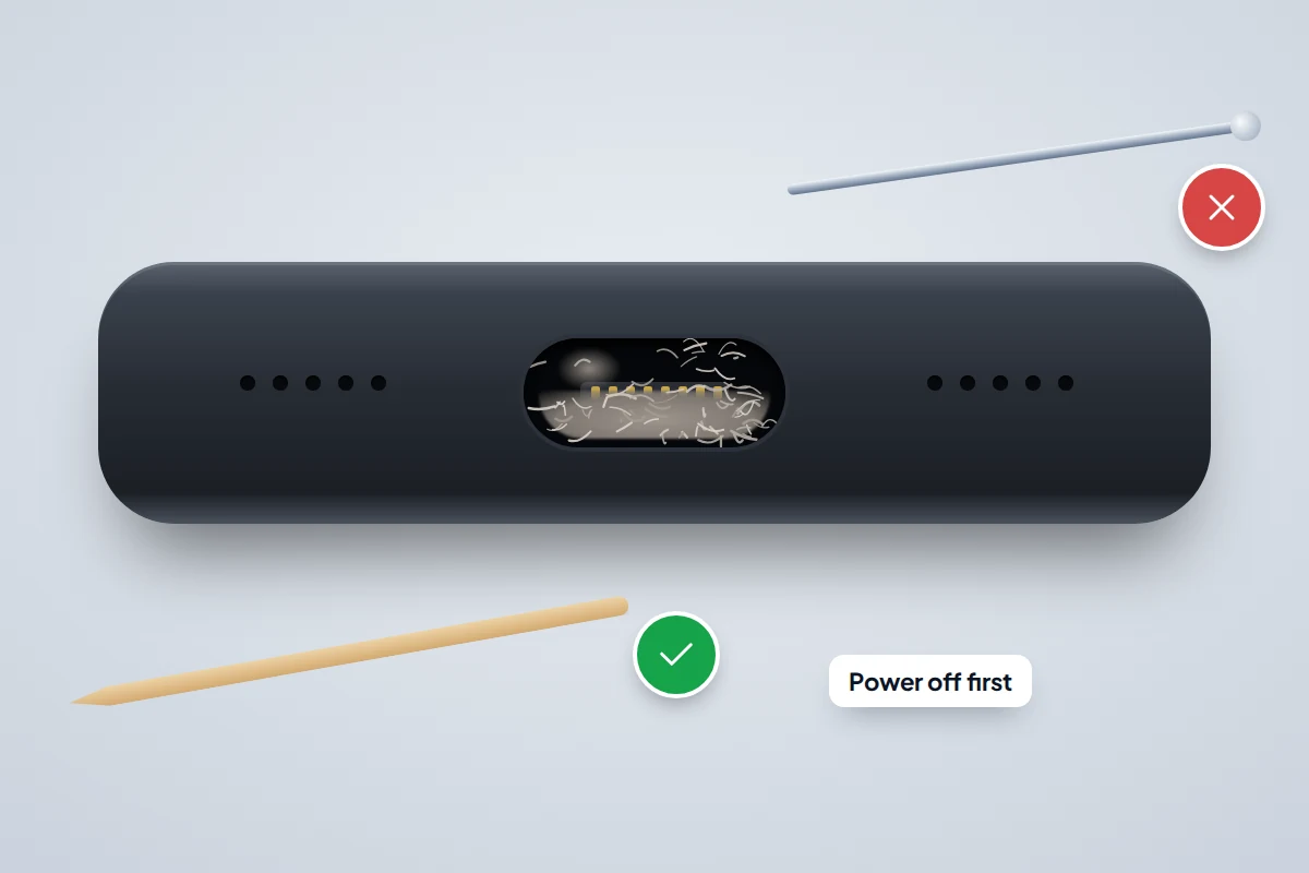 Close-up of a phone's charging port packed with grey lint, with a wooden toothpick ticked and a metal pin crossed out