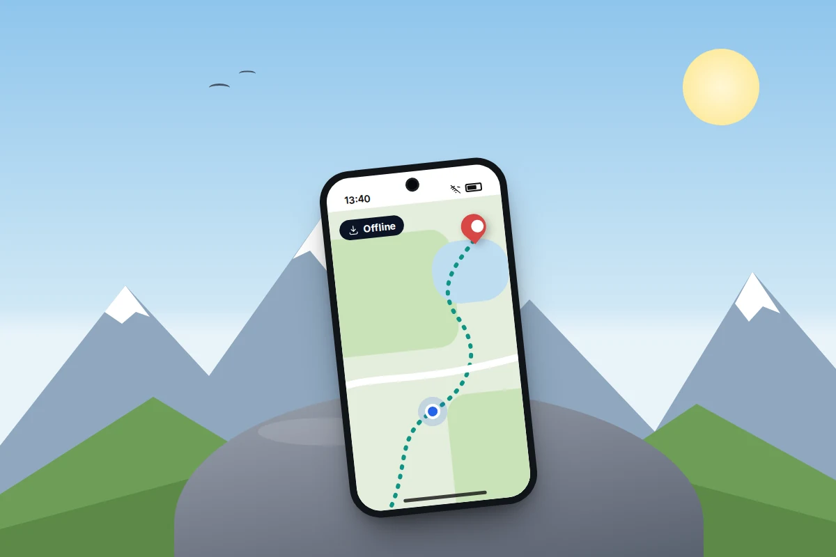 A phone resting on a rock with mountains behind, showing a downloaded offline map with a walking route