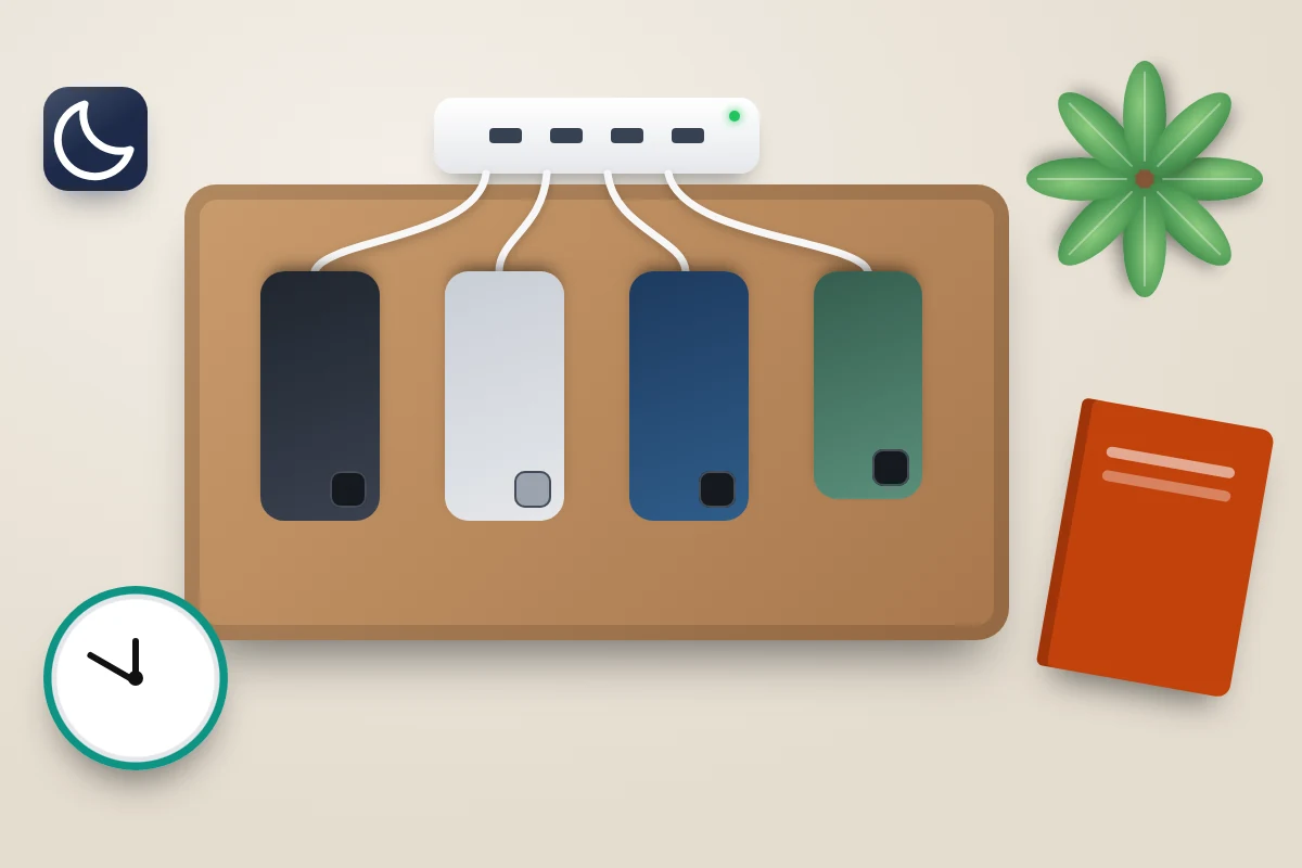 Wooden tray with four phones face down charging from one hub, beside an alarm clock, a book and a plant