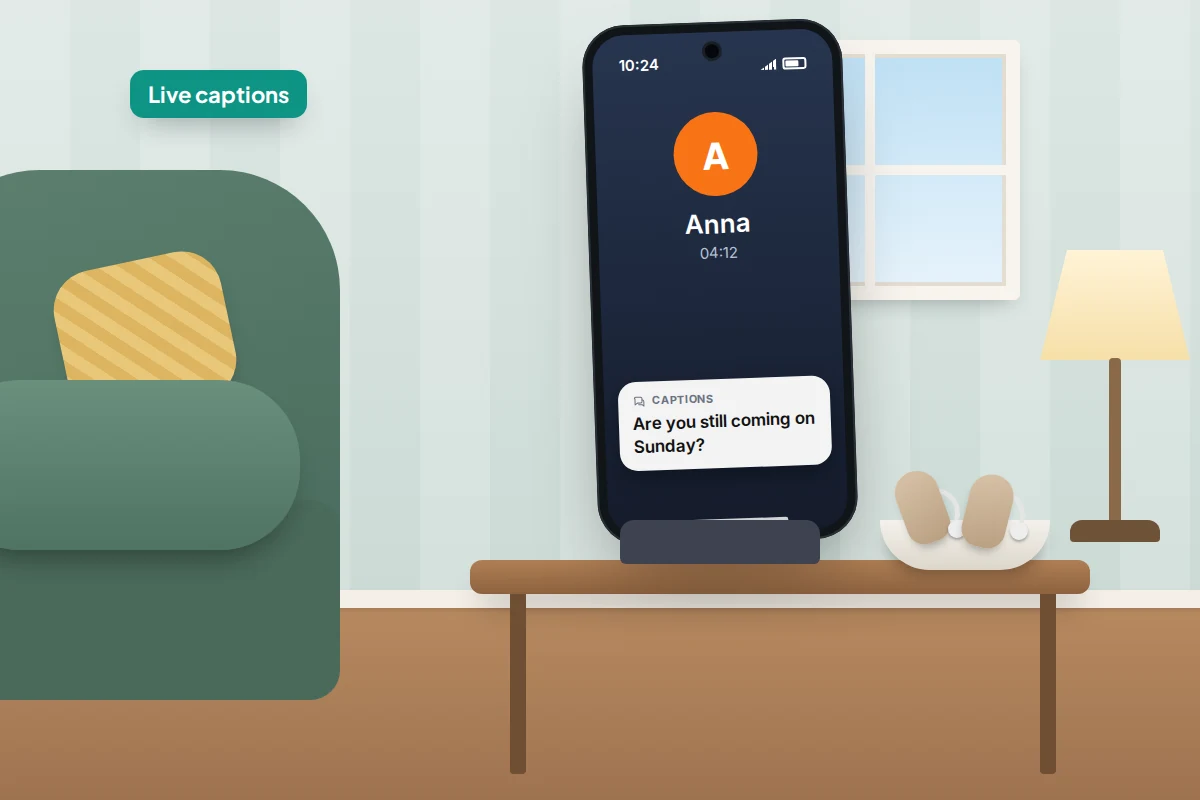 A phone on a stand on a side table by an armchair, showing a call with captions, beside hearing aids in a small dish
