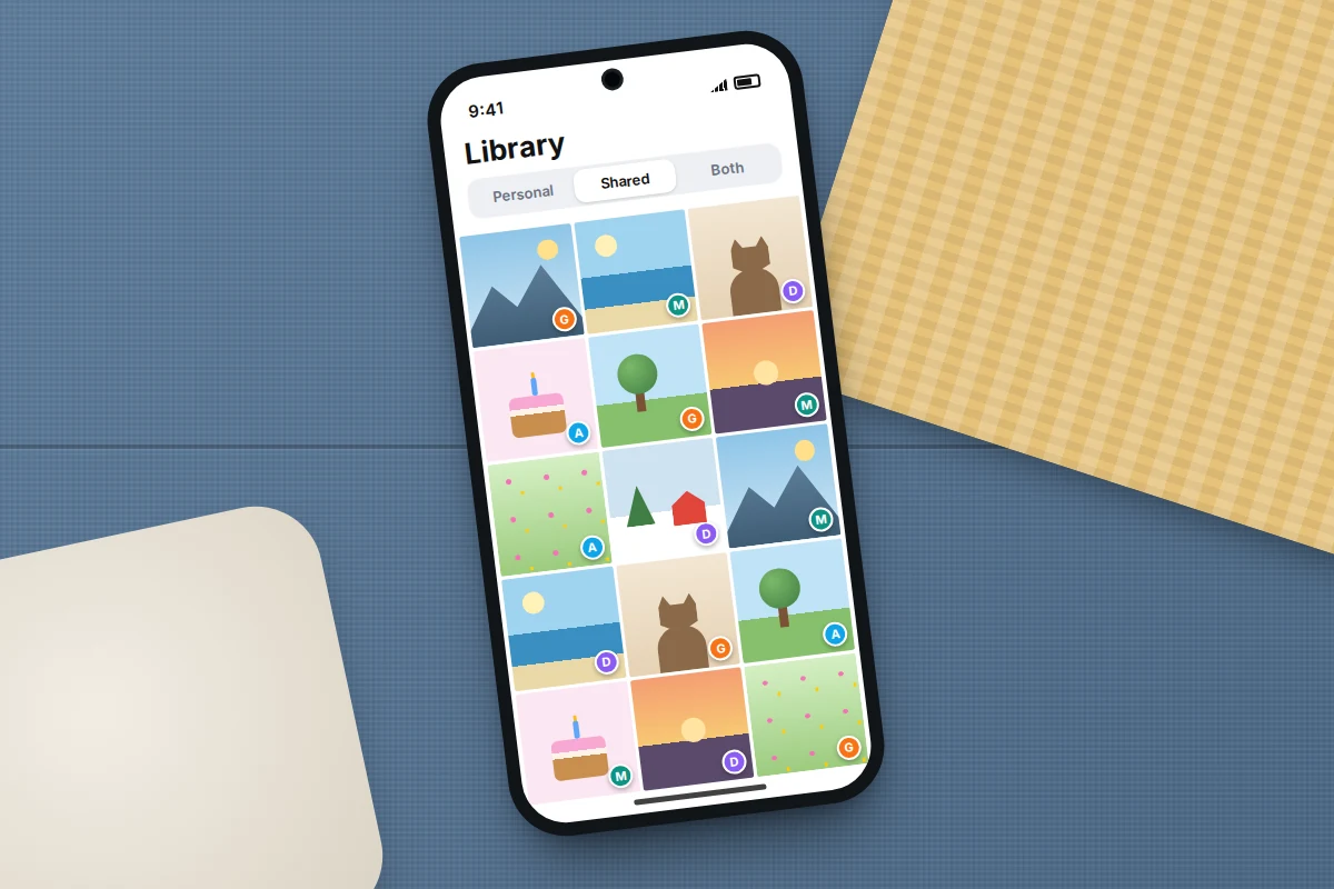 Close-up of a phone on a sofa showing a shared library grid of landscape, pet and birthday cake thumbnails