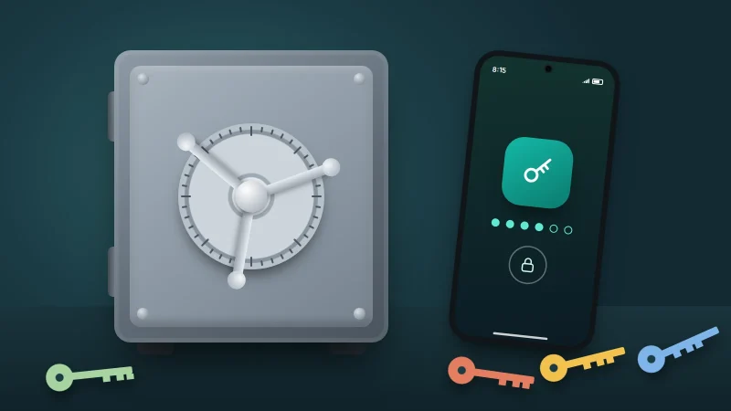 A steel safe with a combination dial beside a phone showing a key app, with coloured keys scattered on the floor