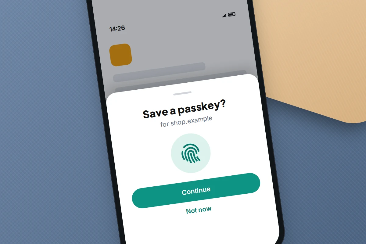 Close-up of a phone screen asking to save a passkey for a shopping site, with a fingerprint icon