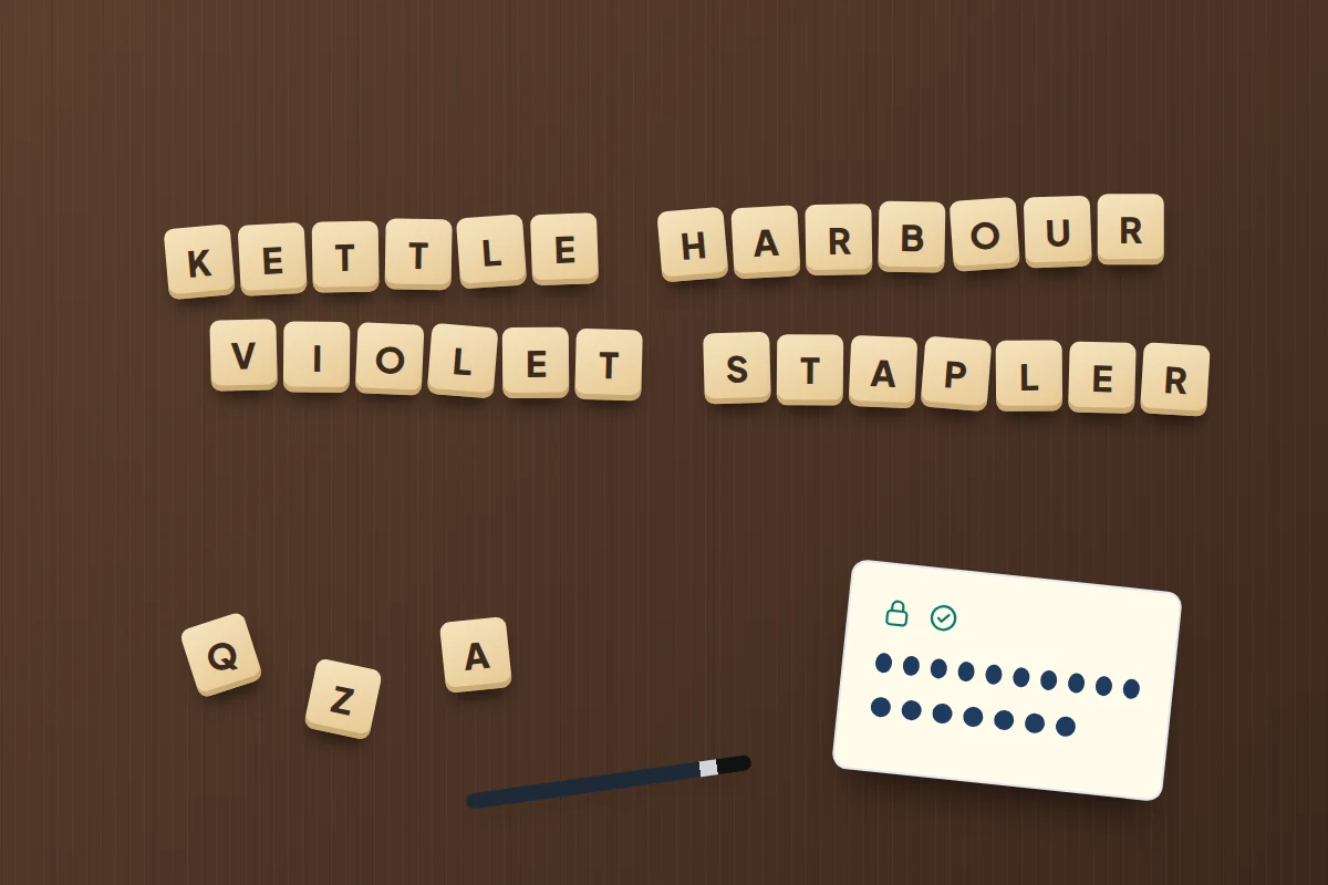 Wooden letter tiles spelling four random words in two rows on a dark table, beside a card of password dots