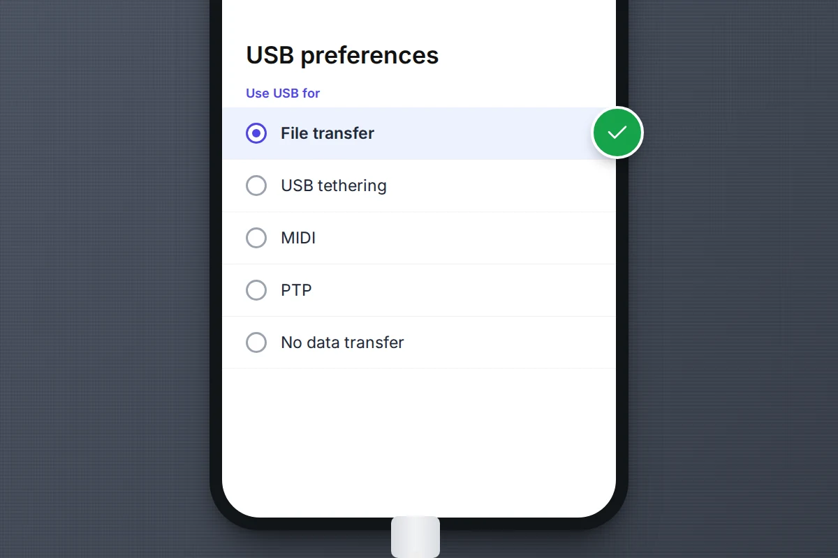 Close-up of a phone screen listing USB options, with file transfer selected and a cable plugged into the bottom